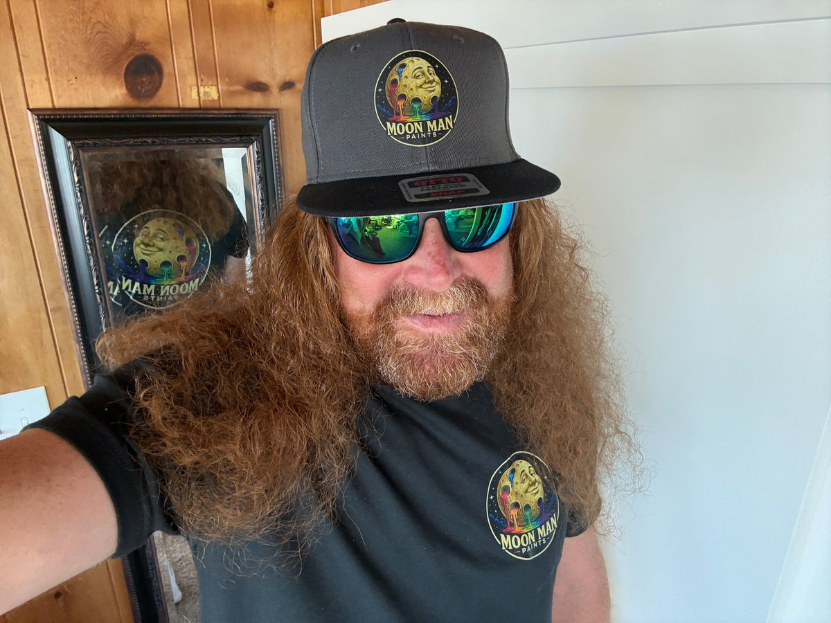 The Moon Man wearing the Original Paint Crater snapback and matching shirt — real-life fit
