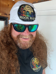 The Moon Man wearing the white Original Paint Crater beanie and matching shirt — real-life fit